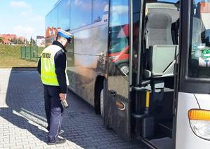 Policjant kontrolujący autobus przez wyjazdem na wycieczkę
